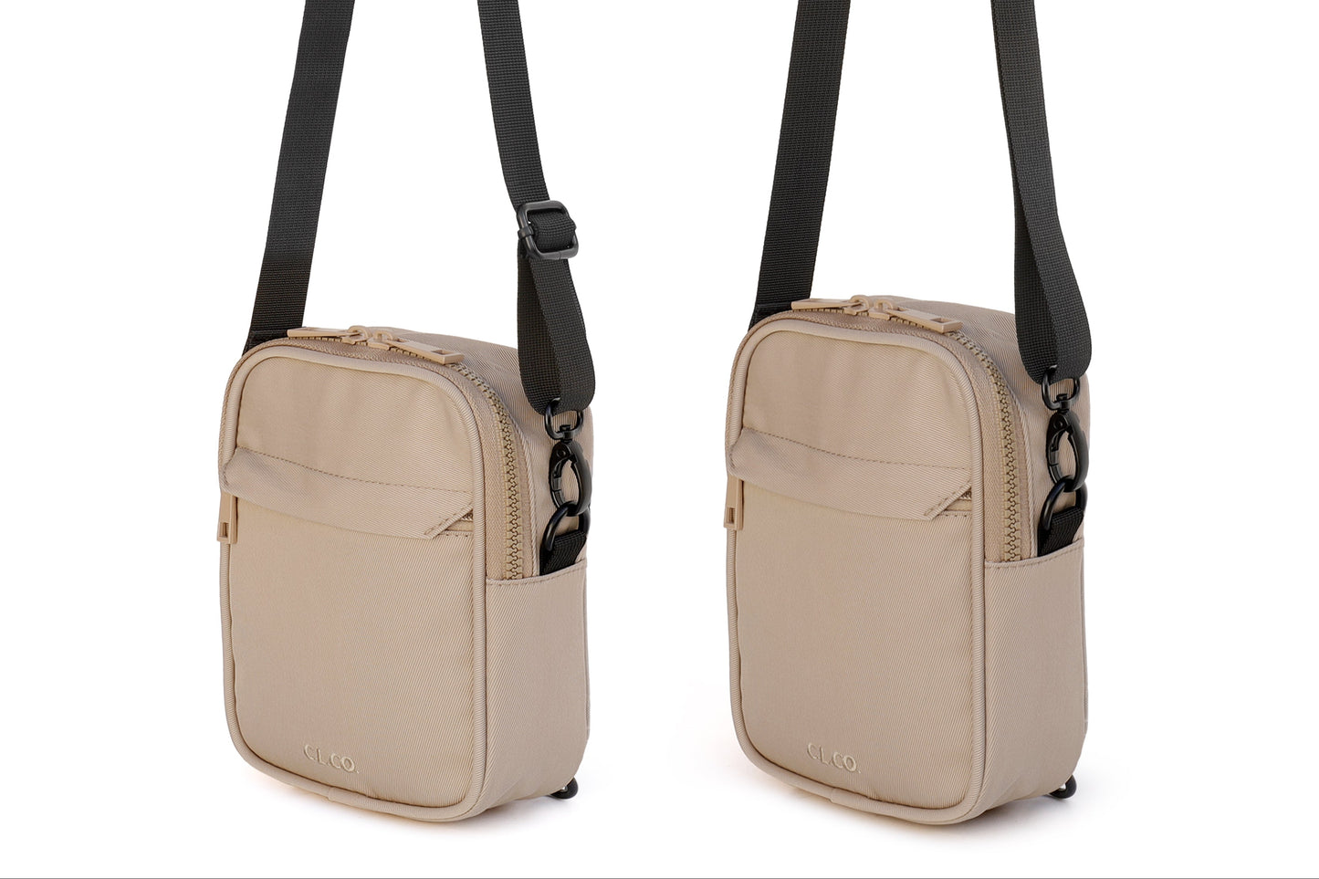 Beige crossbody bag with black strap on a white background