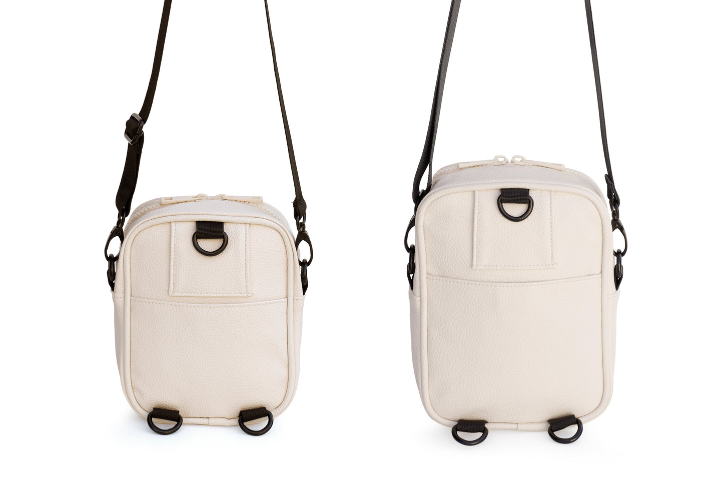 Two beige crossbody bags with black straps on a white background