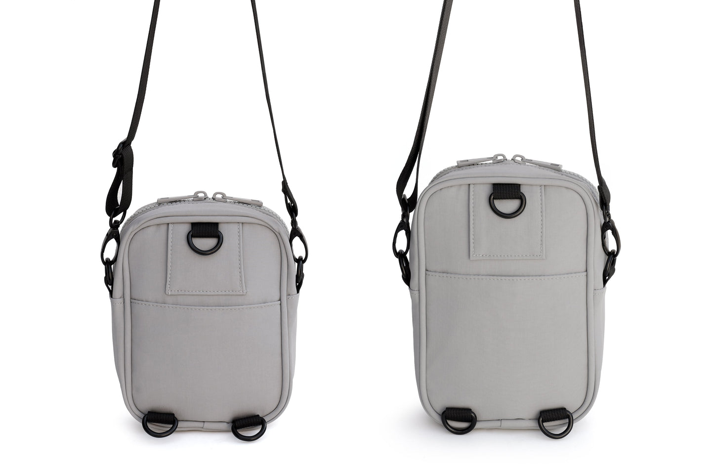 Two gray crossbody bags with black straps on a white background