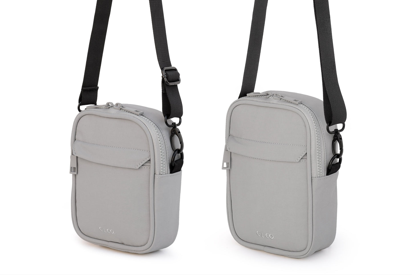 Two gray crossbody bags with black straps on a white background
