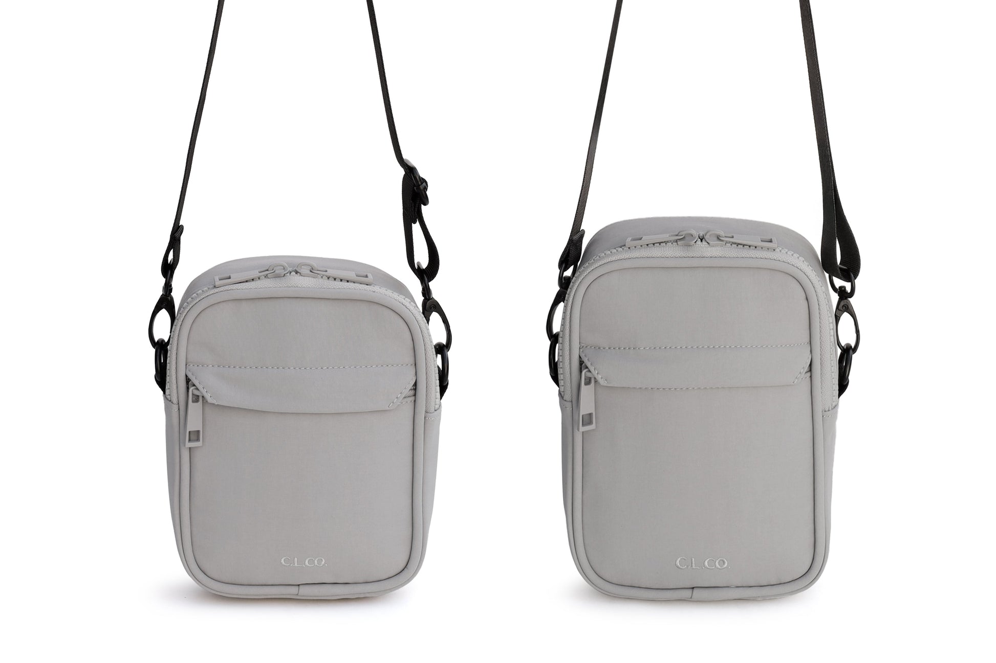 Two gray crossbody bags with straps on a white background